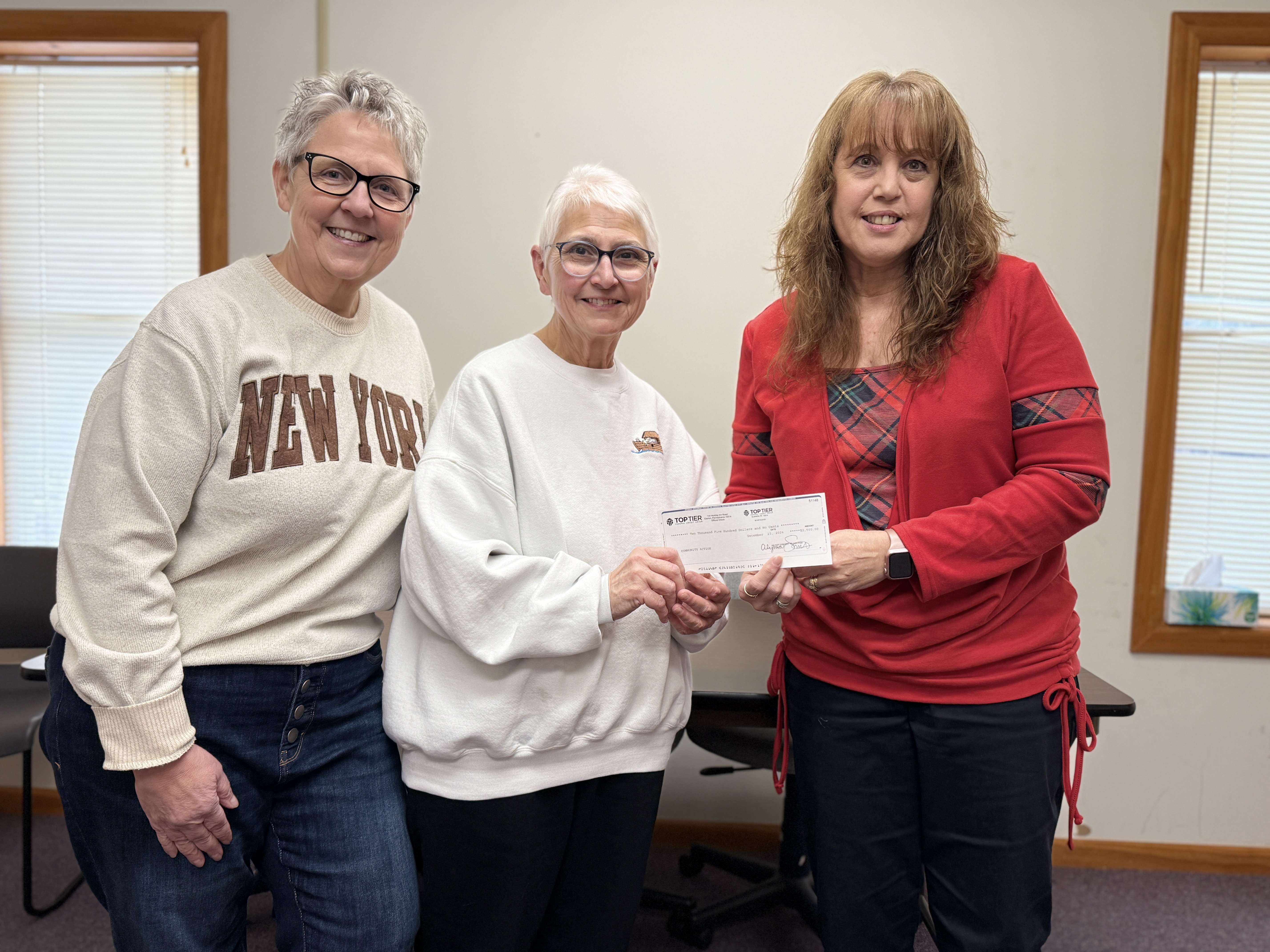 Jayne Daugherty, Joan Kriebel, presented a check for $2,500 to Cheryl Craft for Community Action